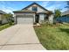 One story home with gray siding and two car garage at 13292 Sea Bridge Dr, Hudson, FL 34669