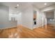 Hardwood floor hallway with laundry room and multiple doors at 825 Islebay Dr, Apollo Beach, FL 33572