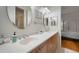 Double vanity bathroom with light wood cabinets and oval mirrors at 825 Islebay Dr, Apollo Beach, FL 33572