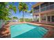 Private pool with brick deck and canal view next to two-story home at 825 Islebay Dr, Apollo Beach, FL 33572