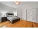 Bright bedroom with hardwood floors, double doors, and ample closet space at 825 Islebay Dr, Apollo Beach, FL 33572