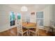 Bright dining room features a wood table and white chairs, with access to a deck at 825 Islebay Dr, Apollo Beach, FL 33572