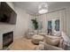 Cozy living room with fireplace, hardwood floors, and comfortable seating at 825 Islebay Dr, Apollo Beach, FL 33572