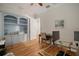 Home office with hardwood floors, built-in shelving, and french doors at 825 Islebay Dr, Apollo Beach, FL 33572