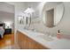 Double vanity bathroom with light wood cabinets and oval mirrors at 825 Islebay Dr, Apollo Beach, FL 33572