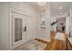 Bright and airy entryway with white plantation shutters and hardwood floors at 825 Islebay Dr, Apollo Beach, FL 33572