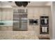 Modern kitchen boasts stainless steel appliances and light cream cabinets at 825 Islebay Dr, Apollo Beach, FL 33572