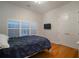 Comfortable bedroom with double bed and hardwood floors at 825 Islebay Dr, Apollo Beach, FL 33572