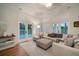 Spacious living room with a sectional sofa and access to a pool area at 825 Islebay Dr, Apollo Beach, FL 33572