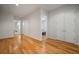 Hardwood floor hallway with doors to bedrooms and additional living space at 825 Islebay Dr, Apollo Beach, FL 33572