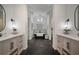 Modern bathroom with double vanity, freestanding tub, and dark tile floors at 825 Islebay Dr, Apollo Beach, FL 33572