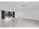 Bright and spacious living room with tile floors and sliding glass doors leading to patio at 1332 Maybury Dr, Holiday, FL 34691