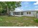 Home features a large backyard with a screened patio at 1332 Maybury Dr, Holiday, FL 34691