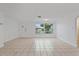 Bright living room with tile floors and large windows at 1332 Maybury Dr, Holiday, FL 34691