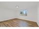 Bright bedroom with wood-look floors and a window at 1332 Maybury Dr, Holiday, FL 34691