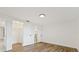 Bedroom with wood-look floors and access to bathroom and closet at 1332 Maybury Dr, Holiday, FL 34691