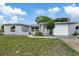 Newly renovated light blue home with a white garage at 1332 Maybury Dr, Holiday, FL 34691