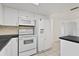White appliances and dark countertops in this kitchen at 1332 Maybury Dr, Holiday, FL 34691