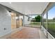 Screened porch with tiled floor and access to backyard at 1332 Maybury Dr, Holiday, FL 34691