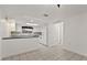 Kitchen features white cabinets, dark countertops, and white appliances at 1332 Maybury Dr, Holiday, FL 34691