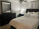 Spacious bedroom with a dark dresser and a comfortable bed at 6115 7Th Ave, New Port Richey, FL 34653