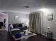 Cozy living room with comfortable seating and dark hardwood floors at 6115 7Th Ave, New Port Richey, FL 34653
