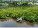 Aerial view of home with a dock surrounded by mangroves at 1215 Bayshore Dr, Terra Ceia, FL 34250