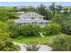 Aerial view of two-story house with lush landscaping at 1215 Bayshore Dr, Terra Ceia, FL 34250