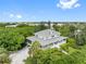 Aerial view of a waterfront home with lush landscaping and a driveway at 1215 Bayshore Dr, Terra Ceia, FL 34250
