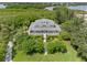 Aerial view of waterfront home with manicured landscaping at 1215 Bayshore Dr, Terra Ceia, FL 34250