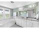 Bright bathroom with double vanity, tub and separate shower at 1215 Bayshore Dr, Terra Ceia, FL 34250