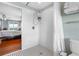 Simple bathroom with shower, toilet, and black and white floor tiles at 1215 Bayshore Dr, Terra Ceia, FL 34250