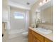 Neat bathroom with tub, toilet, and wood vanity at 1215 Bayshore Dr, Terra Ceia, FL 34250