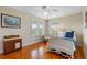 Charming bedroom with hardwood floors and a white bed at 1215 Bayshore Dr, Terra Ceia, FL 34250