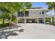 Beautiful home with covered parking, lush landscaping, and a serene setting creates a welcoming ambiance at 1215 Bayshore Dr, Terra Ceia, FL 34250