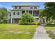 Charming home with lush landscaping, a spacious yard, and inviting architectural details at 1215 Bayshore Dr, Terra Ceia, FL 34250