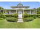 Two-story house with a wraparound porch and manicured landscaping at 1215 Bayshore Dr, Terra Ceia, FL 34250