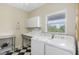 Convenient laundry room with washer, dryer, and utility sink at 1215 Bayshore Dr, Terra Ceia, FL 34250