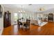 Open-concept living room featuring hardwood floors, dining area, and comfortable seating at 1215 Bayshore Dr, Terra Ceia, FL 34250