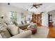 Comfortable living area featuring a ceiling fan, lots of light, and built in book shelves at 1215 Bayshore Dr, Terra Ceia, FL 34250