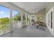 Inviting screened porch with ceiling fan, seating, and serene views offers a relaxing outdoor living space at 1215 Bayshore Dr, Terra Ceia, FL 34250