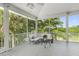 Relaxing screened porch with comfortable seating and scenic views, perfect for enjoying the outdoors at 1215 Bayshore Dr, Terra Ceia, FL 34250