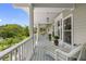 A beautifully decorated porch with comfortable wicker furniture at 1215 Bayshore Dr, Terra Ceia, FL 34250