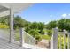 Charming backyard view from the porch with a garden and lawn at 1215 Bayshore Dr, Terra Ceia, FL 34250
