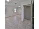Bedroom with gray tile floors, neutral wall paint, and an open closet door at 3908 W Wallace Ave, Tampa, FL 33611
