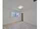 Bright bedroom featuring tile floors, a window with curtains, and a standard ceiling light fixture at 3908 W Wallace Ave, Tampa, FL 33611