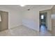 Bedroom featuring tile floors with a standard door and an adjacent room with a bathtub visible at 3908 W Wallace Ave, Tampa, FL 33611