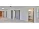 Hallway with neutral walls, gray tile floors, and a view of the bathroom at 3908 W Wallace Ave, Tampa, FL 33611