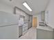 Well-lit kitchen featuring gray cabinets, granite countertops, and stainless steel sink at 3908 W Wallace Ave, Tampa, FL 33611