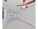 Open living room featuring carpet, ceiling fans, and sliding doors to the outdoors at 3908 W Wallace Ave, Tampa, FL 33611